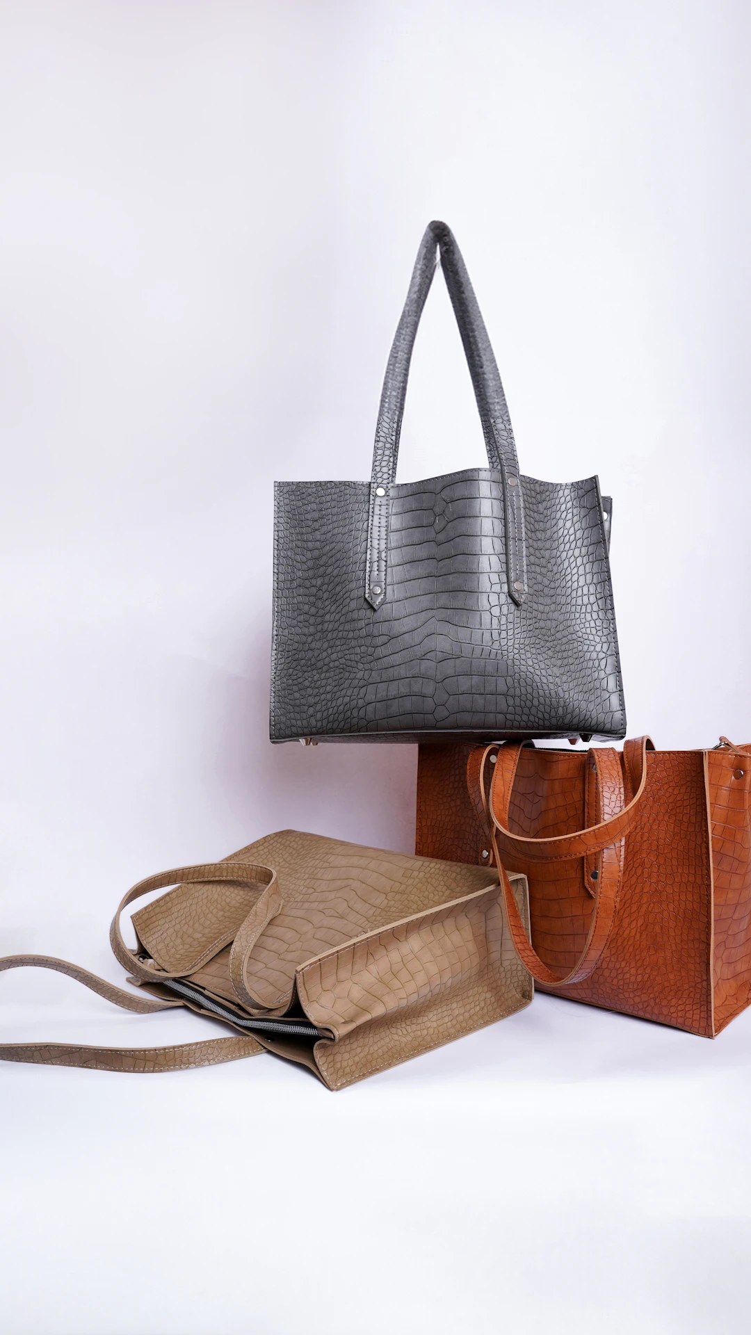 three different types of purses on a white background