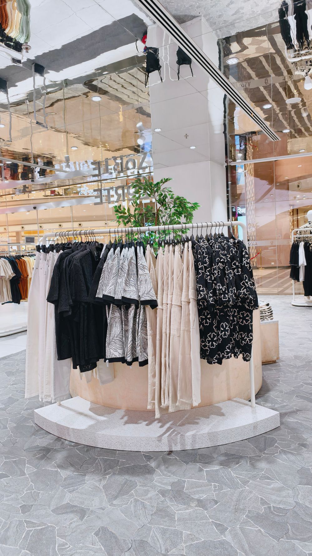 Chic clothing rack in a stylish, contemporary fashion store interior.